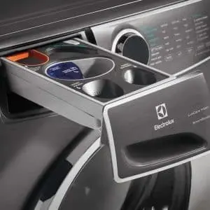 Compact washing machine detergent drawer with Electrolux branding and multiple compartments for laundry products.