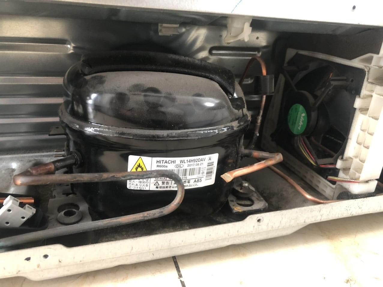 Refrigerant compressor inside an air conditioning unit, showcasing Samsung's reliable cooling system components for Samsung appliances and electronics in Vietnam.