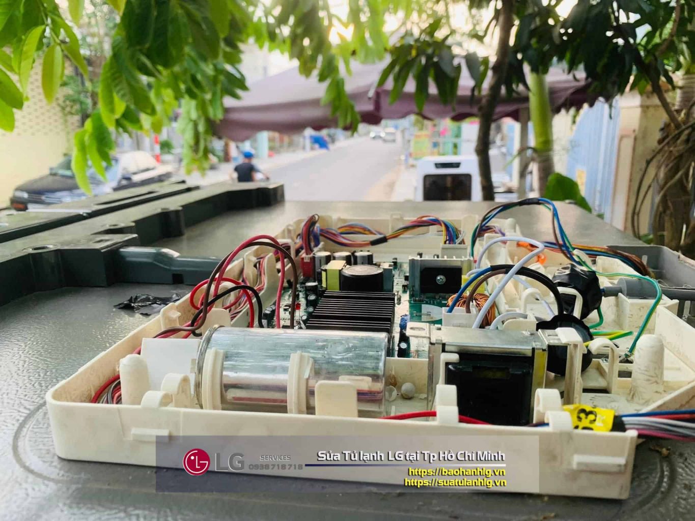 Repairing LG appliance circuit board on the street.