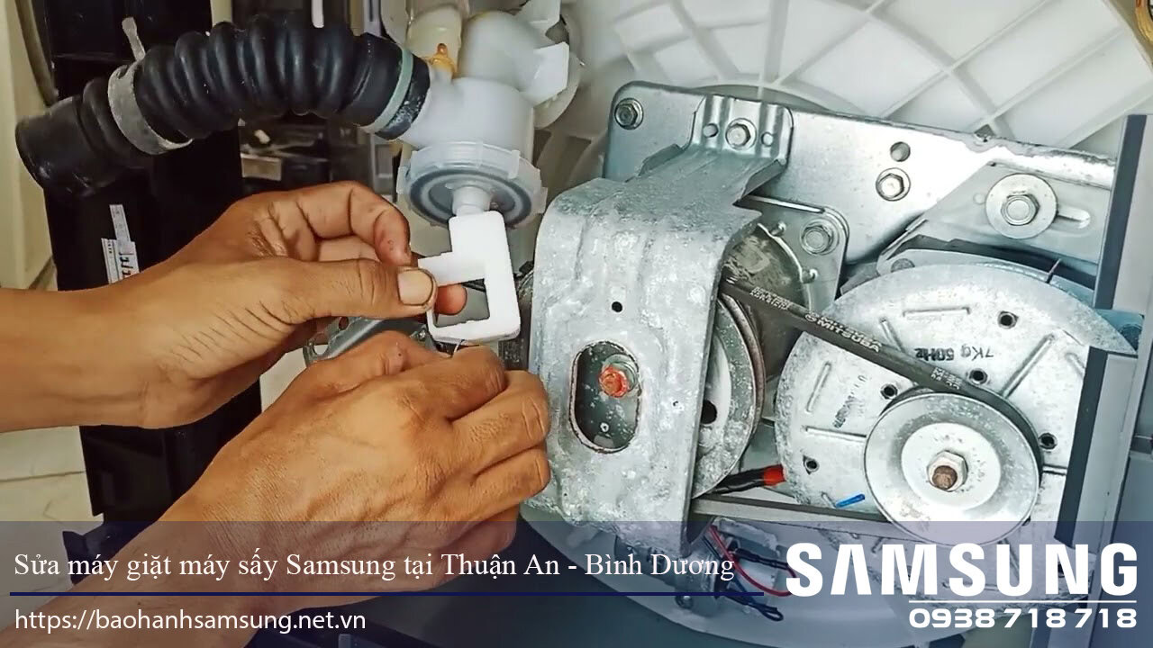 Washing machine repair technician fixing Samsung dryer internal components in Thuận An, Bình Dương. Expert appliance repair service for Samsung washing machines with genuine parts.